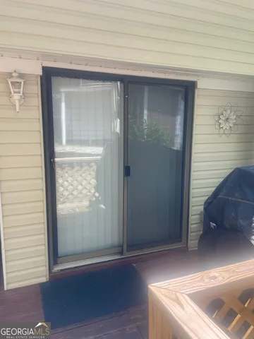 a view of a yard with wooden fence
