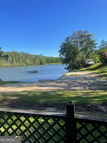 a view of yard with swimming pool and seating area