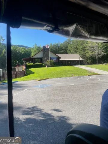 a view of a yard with wooden fence