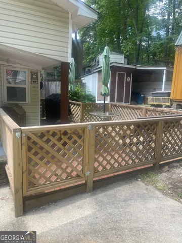 a view of a house with wooden fence
