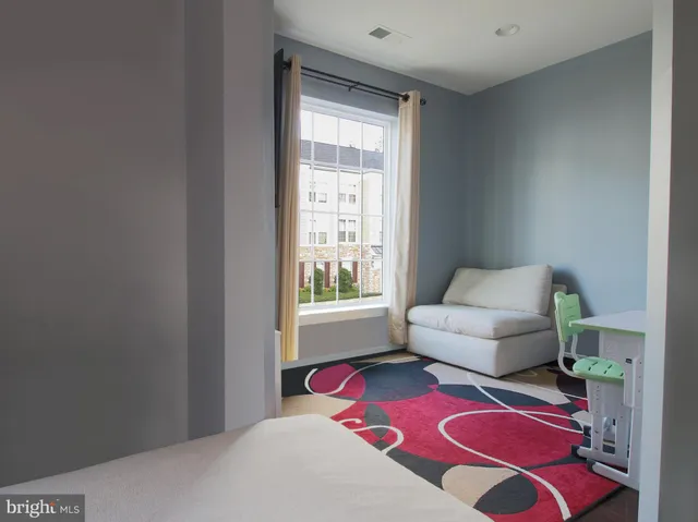a living room with furniture and a rug