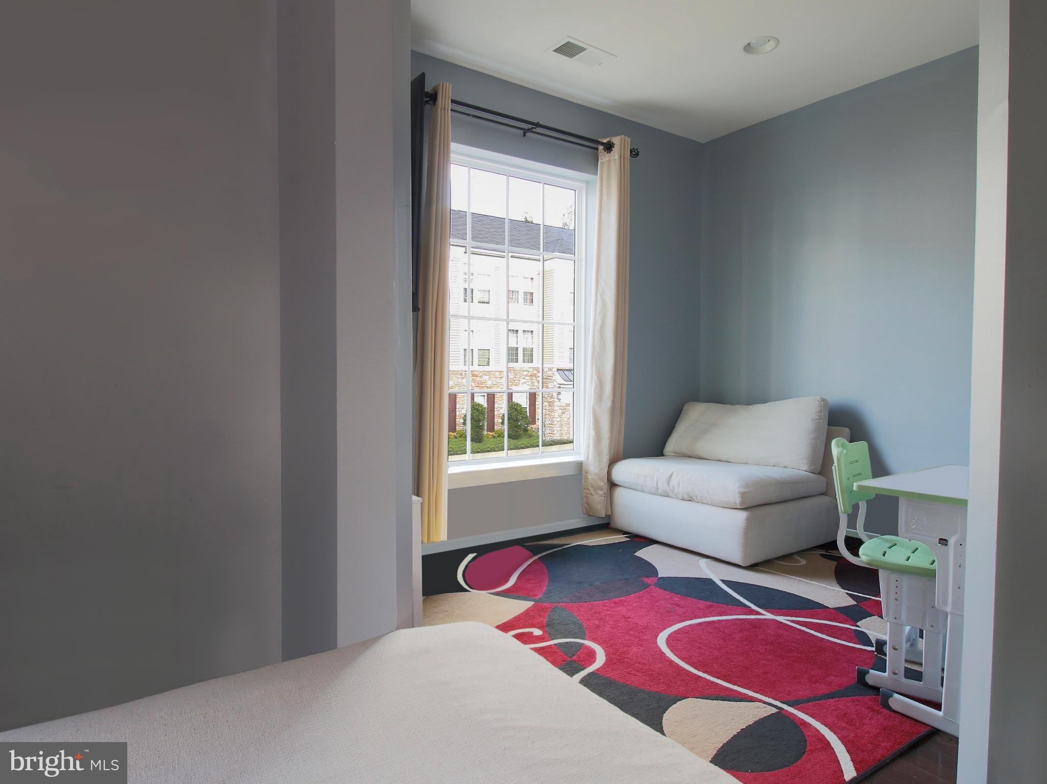 7465 Riding Meadow Way, Unit 42 Manassas, VA 20111 - Photo 13 of 26 a living room with furniture and a rug