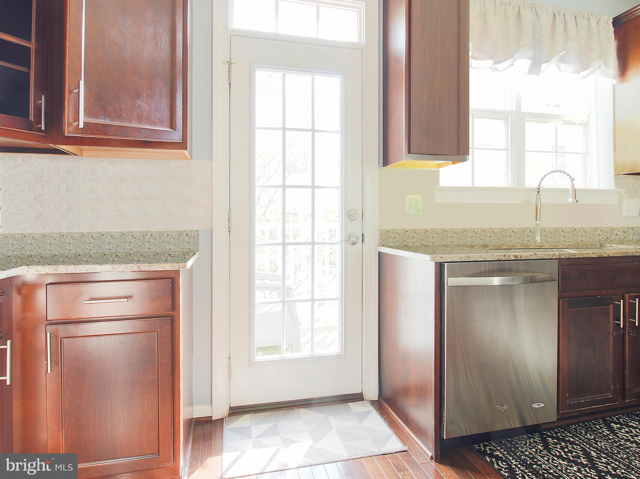 7465 Riding Meadow Way, Unit 42 Manassas, VA 20111 - Photo 15 of 26 a kitchen with granite countertop white cabinets and a window