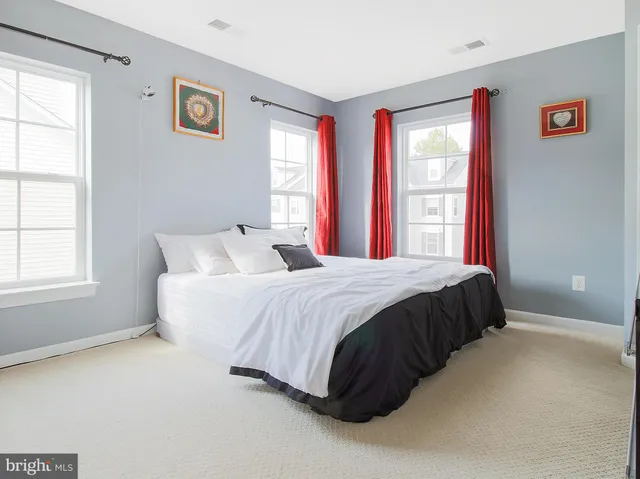 a spacious bedroom with a bed and a window