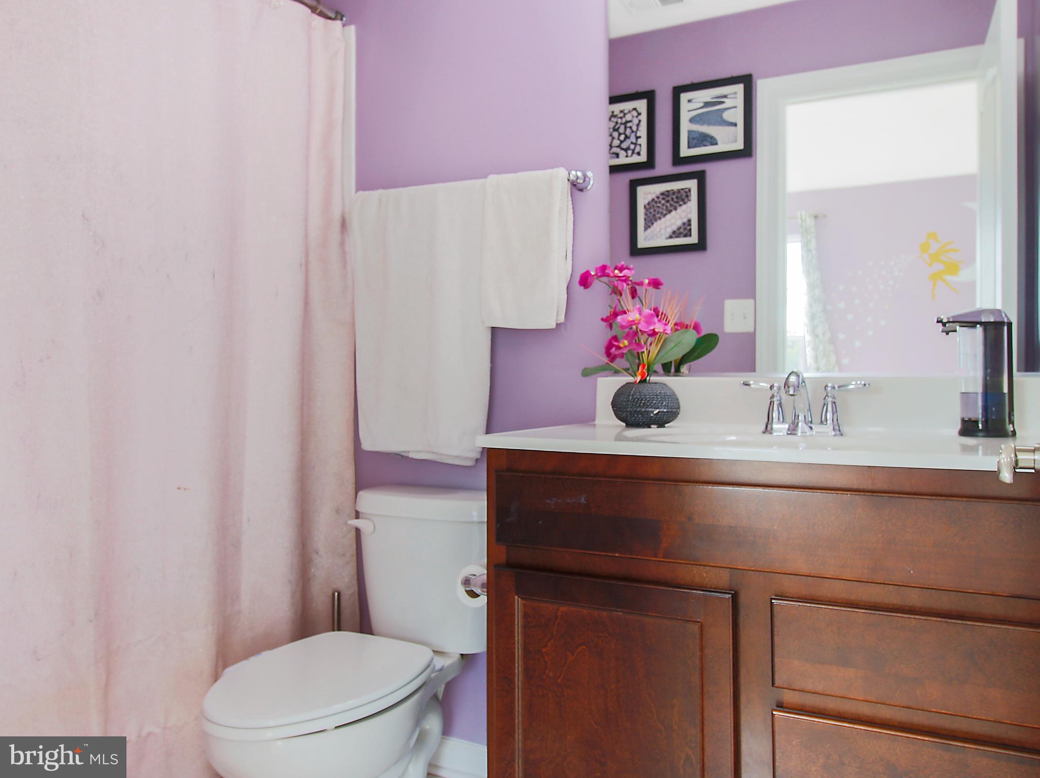 7465 Riding Meadow Way, Unit 42 Manassas, VA 20111 - Photo 23 of 26 a bathroom with a sink vanity mirror and toilet