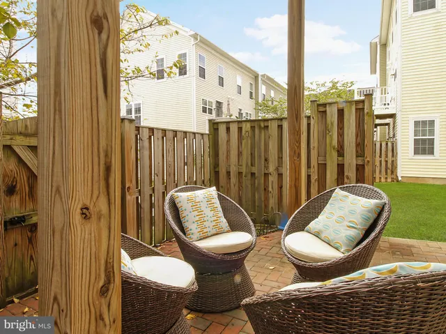 a view of a balcony with chairs and a potted plant