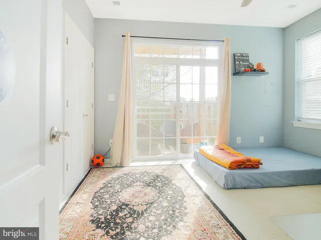 a living room with a bed and a window