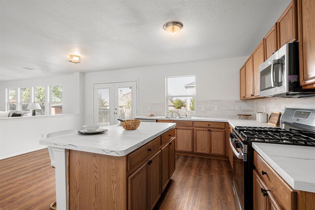 4816 Star Ridge Drive Fort Worth, TX 76133 - Photo 11 of 23 a kitchen with stainless steel appliances granite countertop a sink stove and cabinets