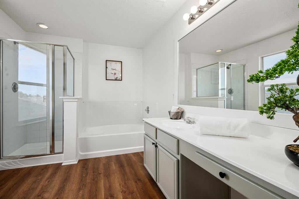 4816 Star Ridge Drive Fort Worth, TX 76133 - Photo 14 of 23 a bathroom with a sink a large mirror and shower