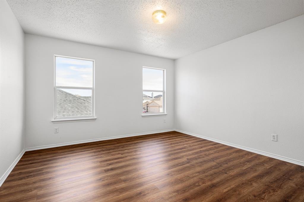 4816 Star Ridge Drive Fort Worth, TX 76133 - Photo 16 of 23 a view of an empty room with wooden floor and a window