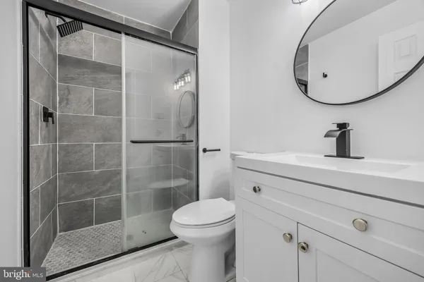 a bathroom with a toilet a sink and shower