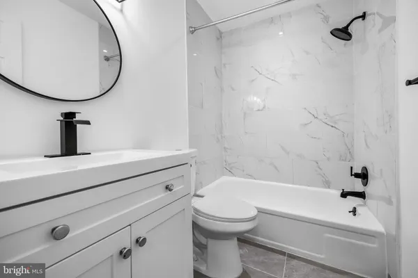 a bathroom with a sink a toilet and a bathtub