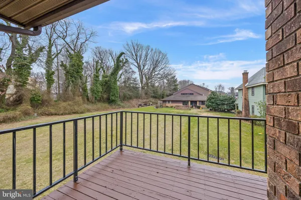 a view of a balcony with wooden floor and fence