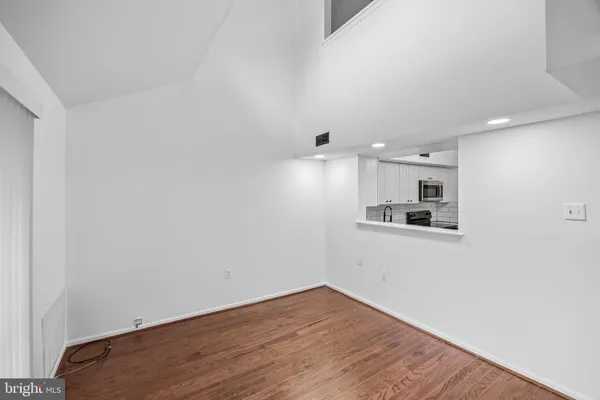a view of a kitchen with wooden floor and a sink