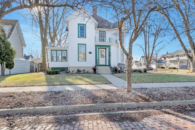 a view of a house with a yard covered in the background