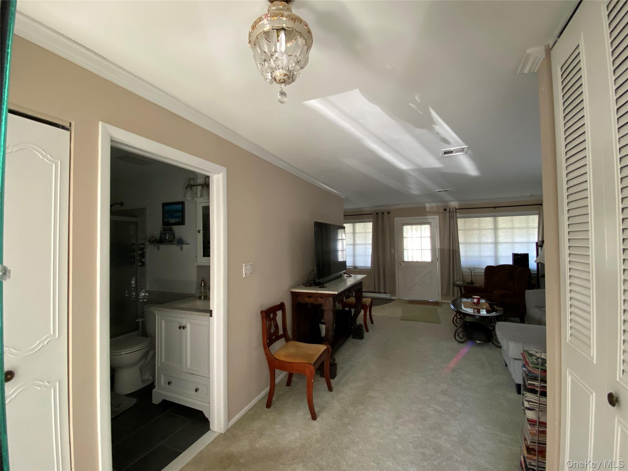 274 Berwick Court, Unit A Ridge, NY 11961 - Photo 22 of 31 Crown molding and light carpet