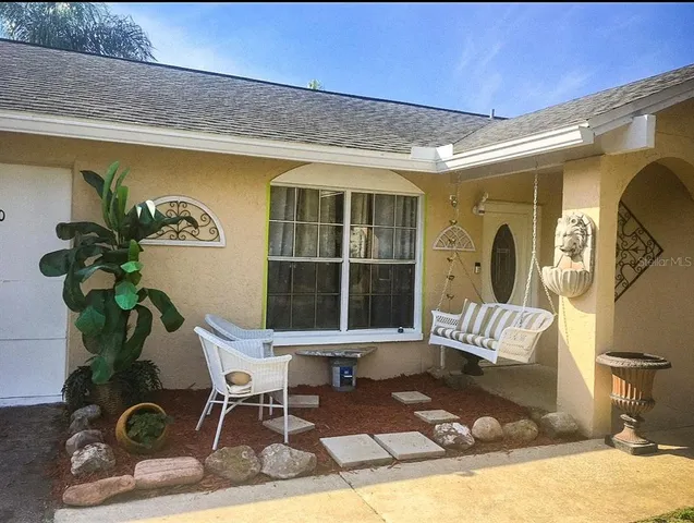 a living room with a couch and a potted plant