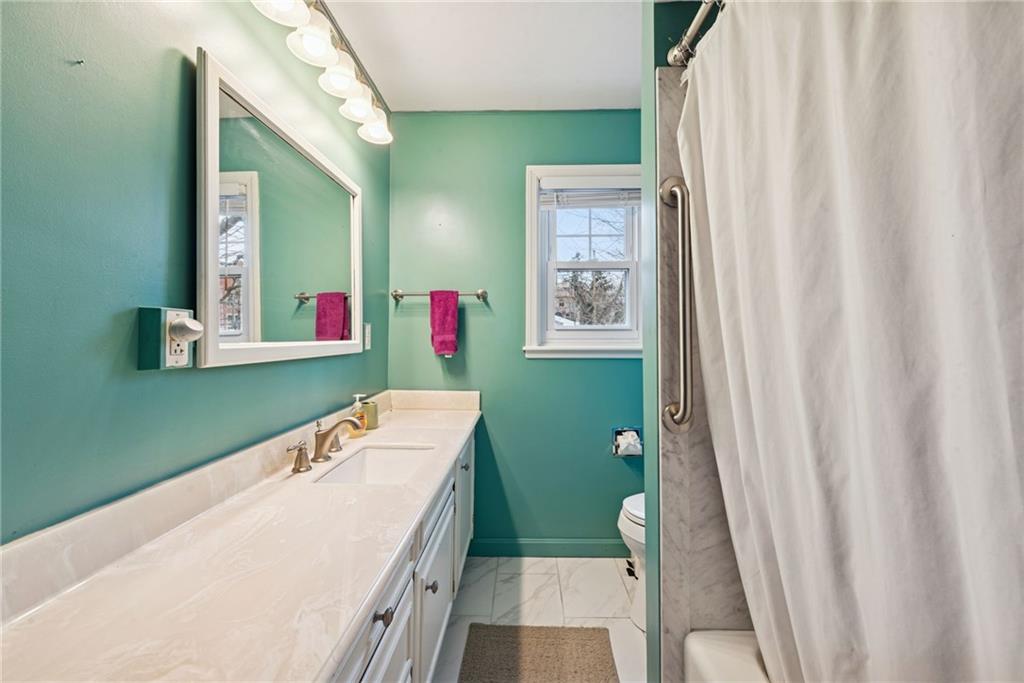 618 State Street Greensburg, PA 15601 - Photo 18 of 34 a bathroom with a sink a toilet and a mirror