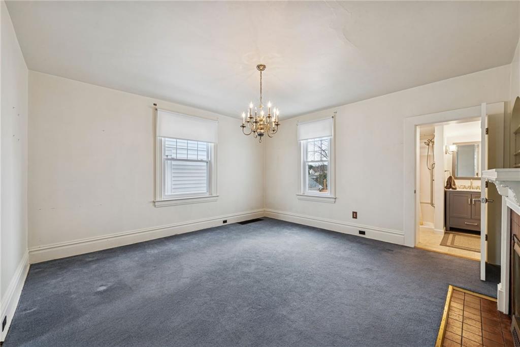 618 State Street Greensburg, PA 15601 - Photo 8 of 34 an empty room with chandelier fan and windows
