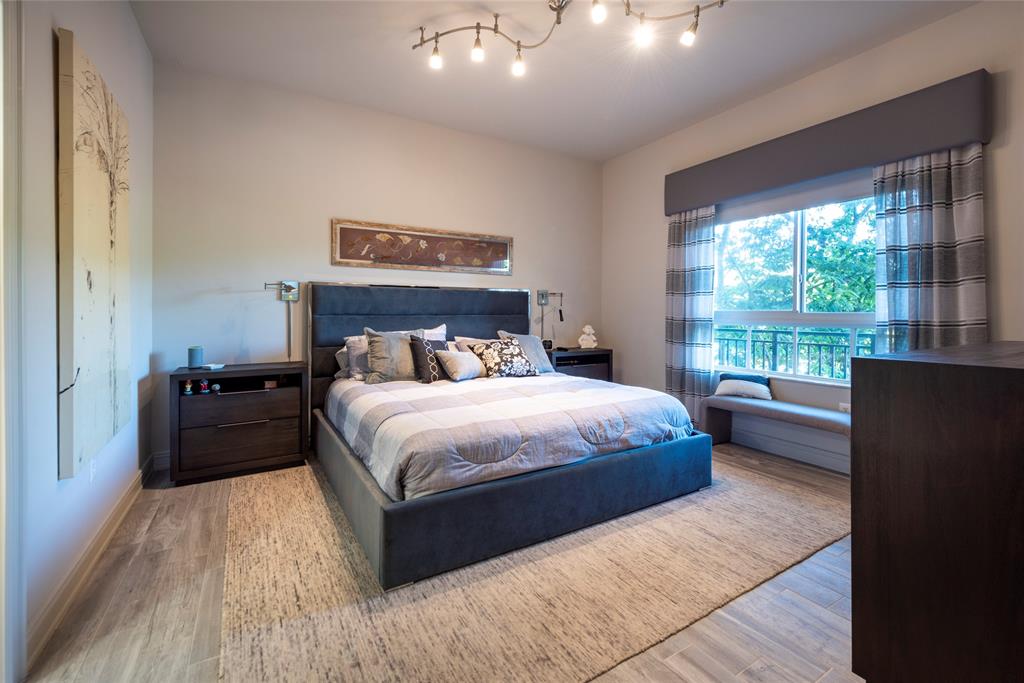 16102 Emerald Estates Drive, Unit 207 Weston, FL 33331 - Photo 14 of 32 a bedroom with a large bed and a large window