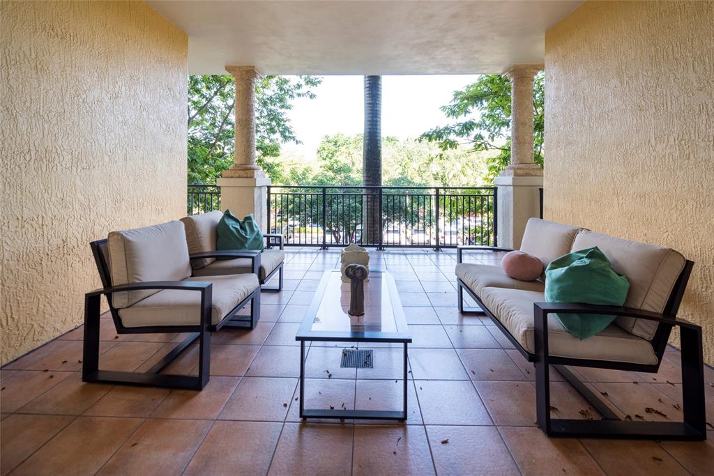 16102 Emerald Estates Drive, Unit 207 Weston, FL 33331 - Photo 20 of 32 a living room with furniture and a floor to ceiling window