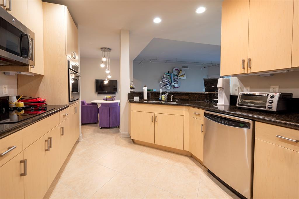 16102 Emerald Estates Drive, Unit 207 Weston, FL 33331 - Photo 2 of 32 a kitchen with granite countertop a sink stainless steel appliances and cabinets