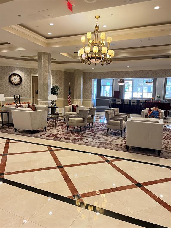 16102 Emerald Estates Drive, Unit 207 Weston, FL 33331 - Photo 24 of 32 a living room with lots of furniture and chandelier