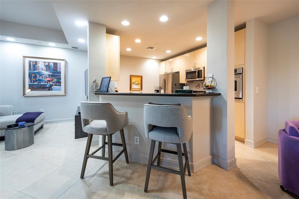 16102 Emerald Estates Drive, Unit 207 Weston, FL 33331 - Photo 5 of 32 a kitchen with a table and chairs in it