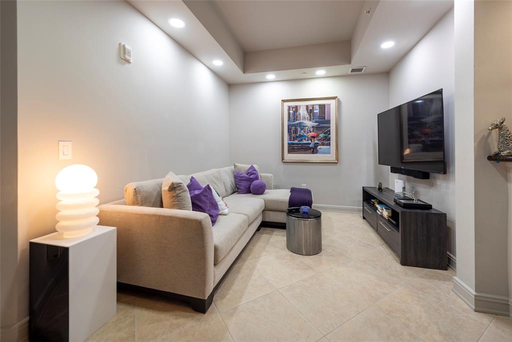 16102 Emerald Estates Drive, Unit 207 Weston, FL 33331 - Photo 7 of 32 a living room with furniture and a flat screen tv