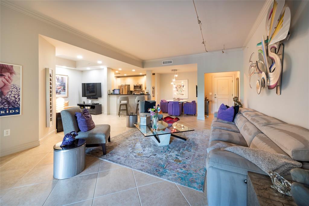 16102 Emerald Estates Drive, Unit 207 Weston, FL 33331 - Photo 9 of 32 a living room with furniture and a flat screen tv