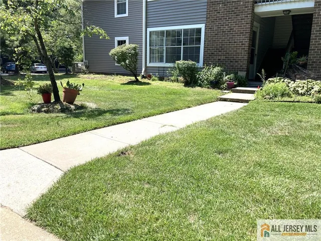 a view of a house with a yard and plants