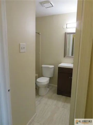a white toilet sitting next to a bathroom sink