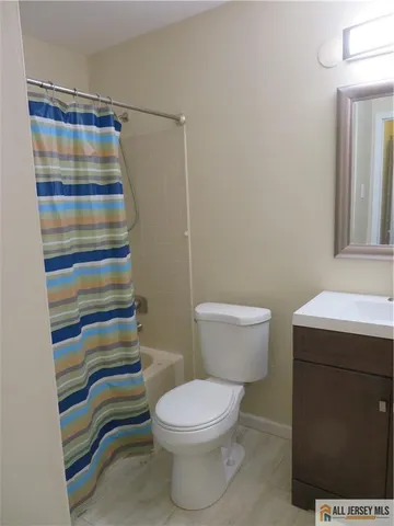 a bathroom with a sink a toilet and a shower