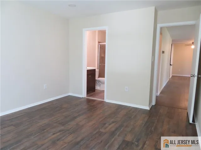 an empty room with wooden floor