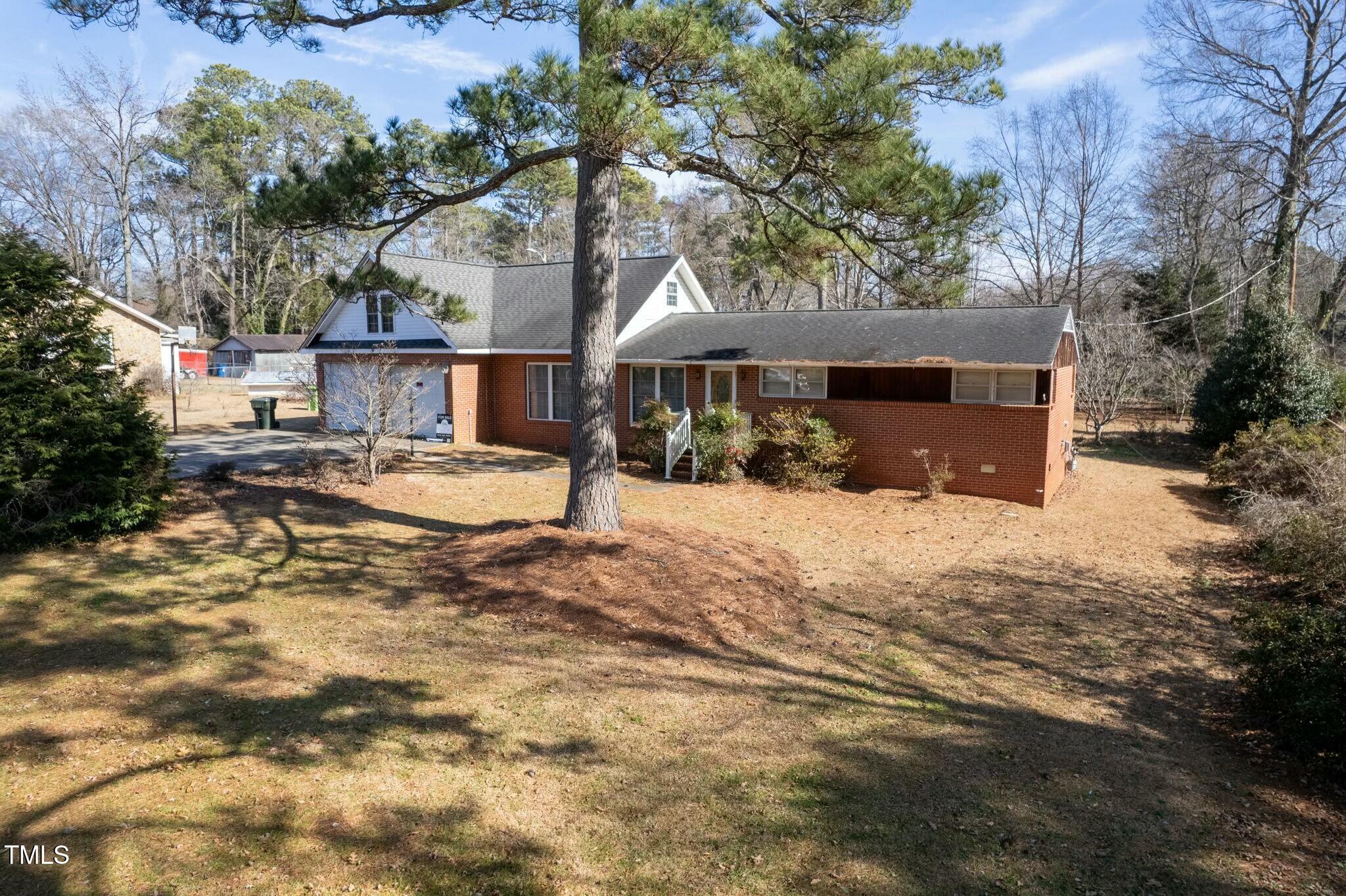 613 Powell Drive Raleigh, NC 27606 - Photo 7 of 27 a view of a house with a yard covered in snow