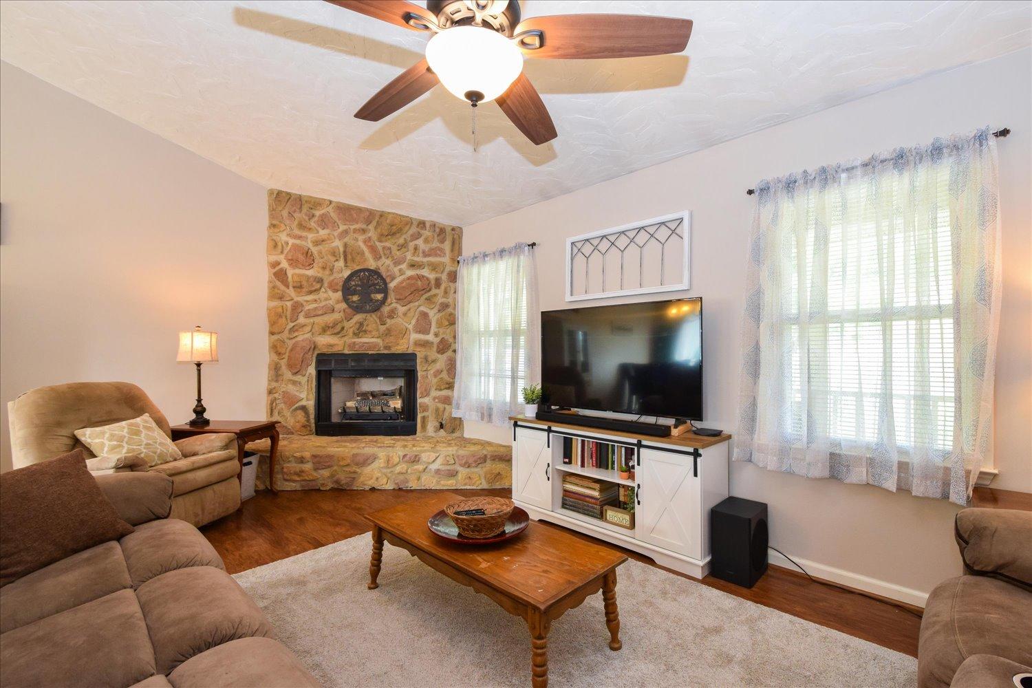 1535 Mountain View Road Vinton, VA 24179 - Photo 3 of 20 a living room with furniture a flat screen tv and a fireplace