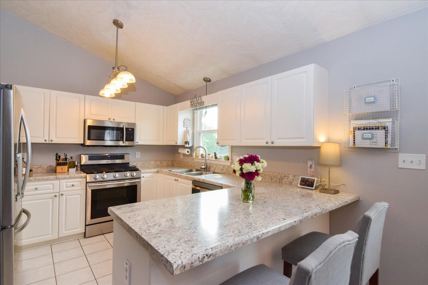 1535 Mountain View Road Vinton, VA 24179 - Photo 6 of 20 a kitchen with stainless steel appliances granite countertop a sink dishwasher a stove a microwave oven with a dining table and chairs