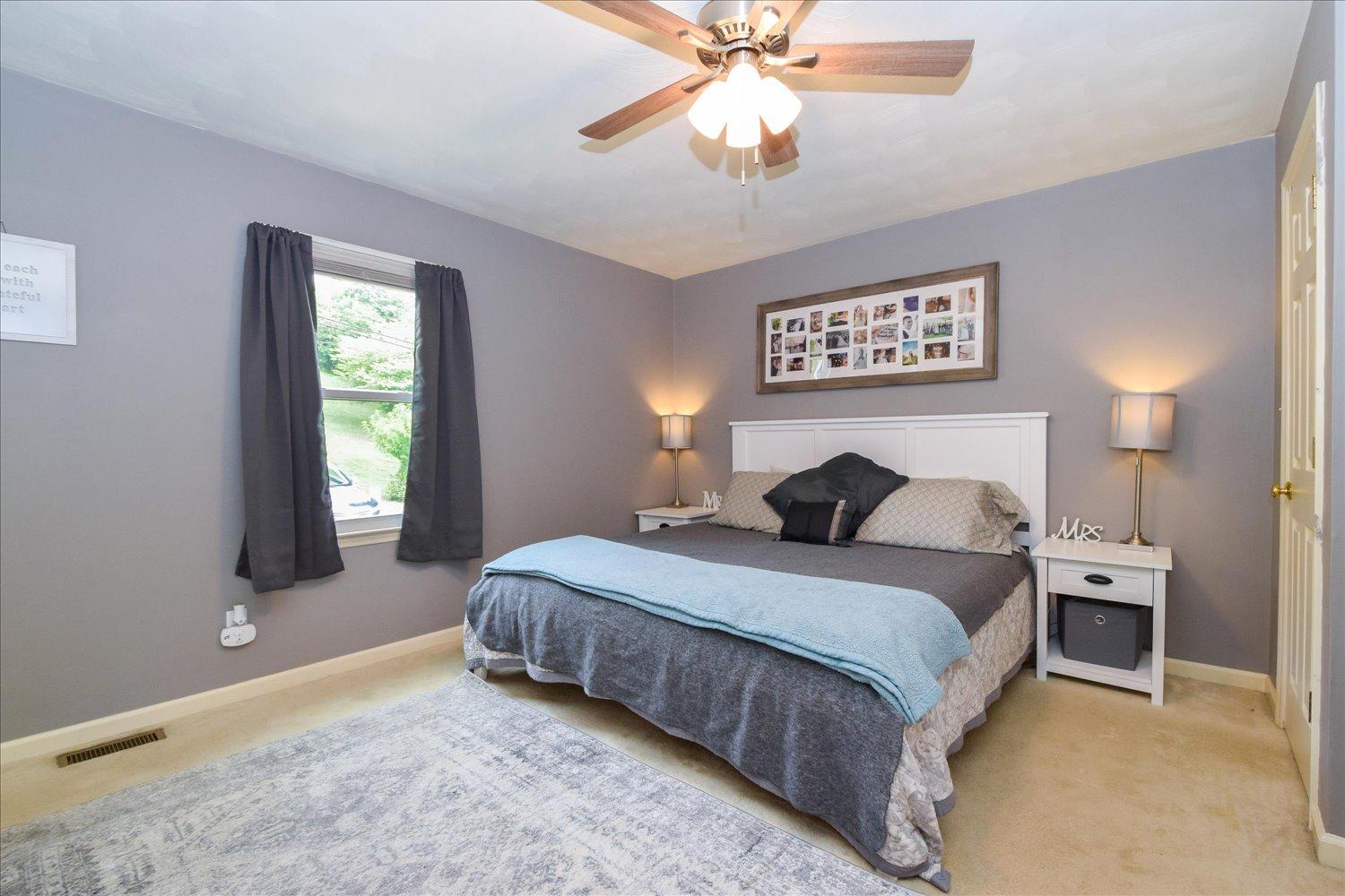 1535 Mountain View Road Vinton, VA 24179 - Photo 8 of 20 a bedroom with a bed and a chandelier