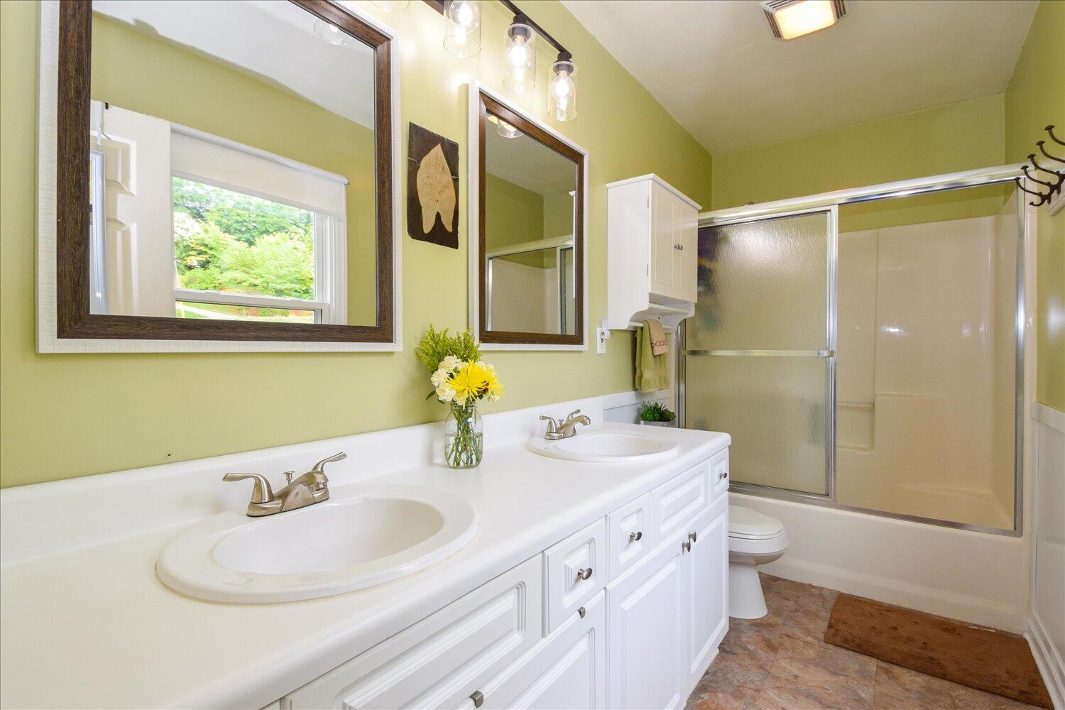 1535 Mountain View Road Vinton, VA 24179 - Photo 9 of 20 a bathroom with a granite countertop sink and a mirror