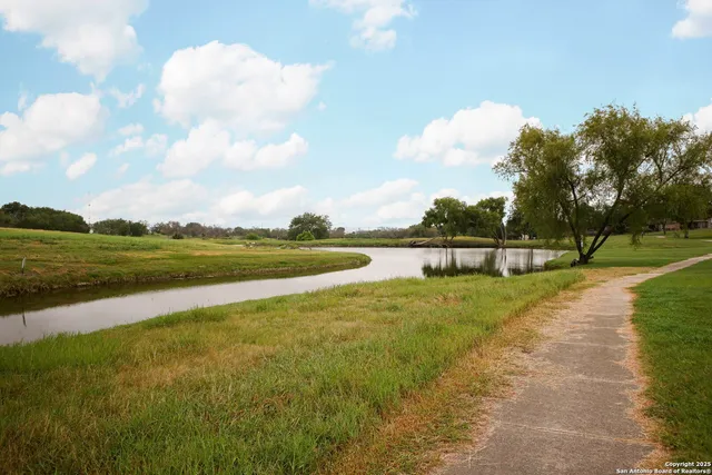 a view of a lake with houses in the background