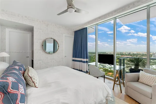 a bedroom with a large bed and a large window