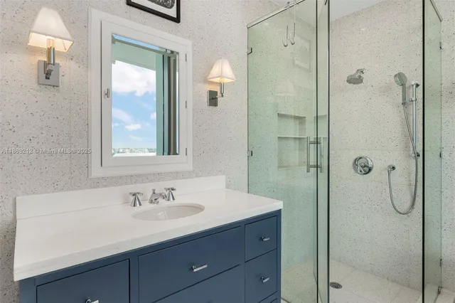 a bathroom with a shower sink and mirror