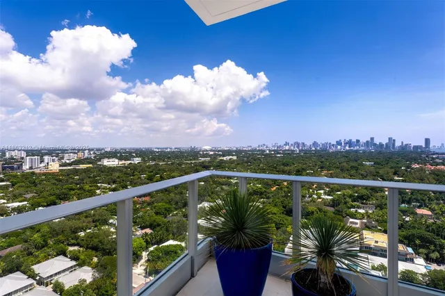 a view of a balcony with lake view and mountain view in back