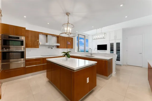 a kitchen with stainless steel appliances granite countertop a sink counter space cabinets and stainless steel appliances