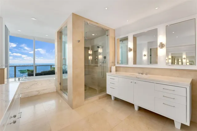 a bathroom with a double vanity sink toilet and shower