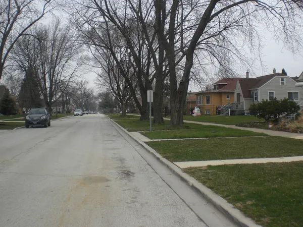 a view of the house with a big yard
