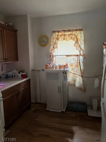 a view of a bathroom with a sink and wooden floor