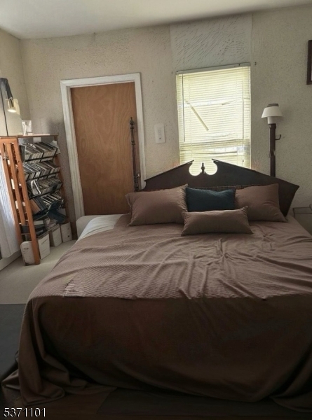 669 Scotland Road, Unit 2 Orange, NJ 07050 - Photo 10 of 10 a bedroom with a bed and dresser with mirror