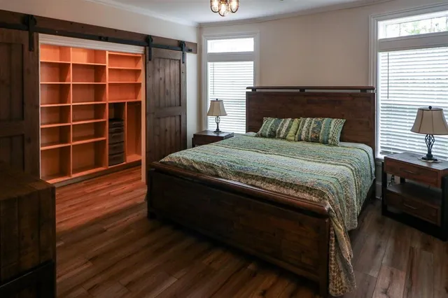 a bed sitting in a bedroom next to a window