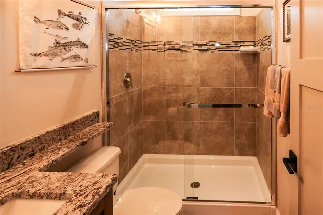 a bathroom with a tub a window and a shower